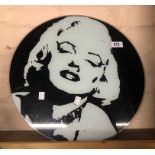 A glass clock face with Marilyn Monroe design