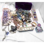 A box containing a quantity of assorted costume jewellery including necklaces, brooches and