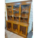 A 1.54m reproduction mahogany wall cabinet with astragal glazed panel doors to top over three