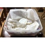 A tub containing a small quantity of table linen including napkins, tray cloths, etc.