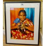 A framed photograph, depicting an Asian girl holding aubergines - titled and dated 1997 - sold