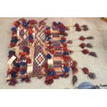 A Moroccan Berber hand made wool saddle bag with geometric design and numerous pom pom tassels - bag