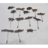 A collection of eight late 20th Century cast silver topped stick pins all featuring animals and