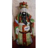 A 20th Century Chinese porcelain figurine depicting a scholar with hand painted decoration
