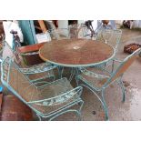A large wrought iron and mesh circular garden table - sold with a set of six matching chairs with