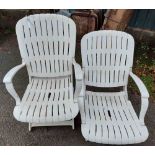 A pair of white plastic folding elbow chairs