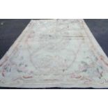 A hand made flat weave carpet with floral motifs on cream ground - 3.75m X 2.75m - grubby