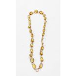 A marked 9ct yellow metal necklace with collar set faceted citrine links