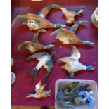 A quantity of vintage ceramic and other flying bird wall plaques including ducks, swallows, etc.