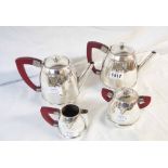 An Art Deco four piece silver plated tea set with applied cast decoration and red bakelite handles