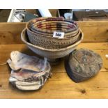 Three Eastern woven baskets, a North African embroidered hat and an old leather pouch