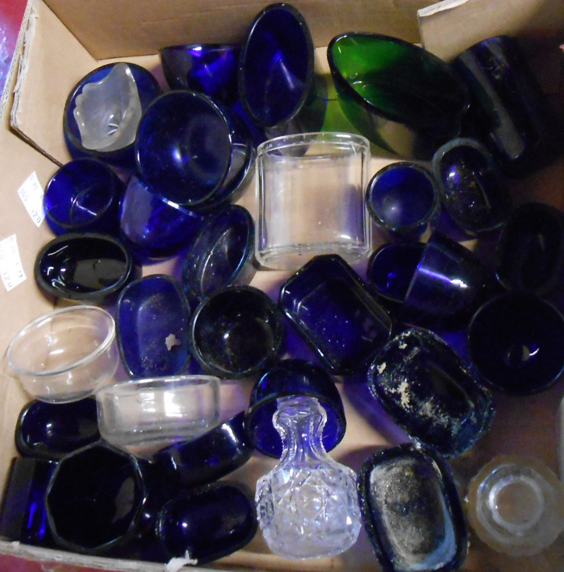 A box containing a quantity of blue glass and other cruet liners, etc.