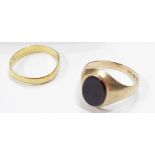 A 375 (9ct.) gold black onyx panel ring - sold with a 22ct. gold wedding band - sizes N 1/2 and M
