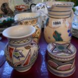 Four pieces of Honiton pottery comprising two jugs, vase with unusual abstract decoration and a