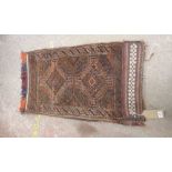 A hand made wool tribal saddle bag with two central motifs within a narrow border on brown