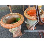 A pair of antique terracotta garden planters of classical pedestal urn form with ribbed decoration -