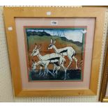 A blonde wood framed Batik picture, depicting three deer in a landscape