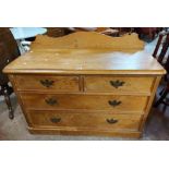 A 1.22m Victorian stripped pine chest of two short and two long graduated drawers, set on plinth