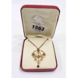 A marked 9ct Edwardian style open scroll and seed pearl set pendant with tiny peridot drop under, on