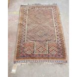 An old hand made prayer mat with geometric design within a double border on russet ground - wear -