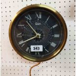 A vintage brassed metal cased Gibson electric wall timepiece - sold as a collectors' item