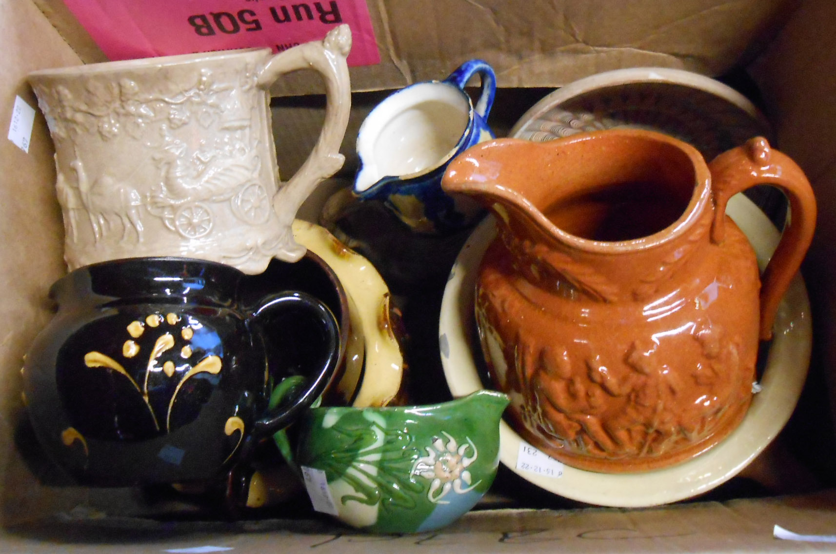 A box containing a quantity of assorted ceramic items including North Devon slip decorated chamber