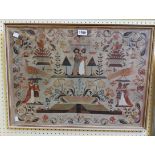 A framed printed copy of a needlework sampler, depicting figures and animals within a foliate