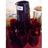 A vintage ruby glass lemonade set comprising jug and four tumblers