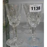 A set of six Waterford Crystal wine glasses with tall bucket bowls and faceted stems