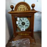 An early 20th Century gilt decorated mahogany cased table alarm clock with large bell to top and
