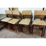 A set of twenty four vintage metal framed stacking chairs with laminated wood backs and seats -