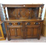 A 1.4m 20th Century polished oak court cupboard in the antique style with canted cupboard and