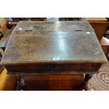 A 63cm antique oak table-top clerk's desk with lift-up slope, set on short turned legs