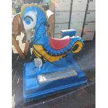 A vintage coin operated children's ride in the form of a seahorse