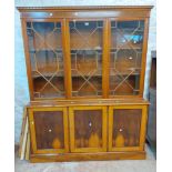 A 1.54m reproduction mahogany wall cabinet with astragal glazed panel doors to top over three