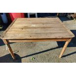 An old pine farmhouse table with plank top, set on turned legs
