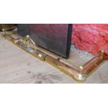 A brass kerb fender with gallery decoration