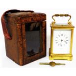 A late 19th Century brass and bevelled glass cased carriage clock with French eight day bell