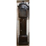 An antique stained oak and mahogany longcase clock case with swan neck pediment and carved floral
