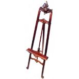 A 19th Century walnut Rococo style picture easel with pierced pediment and further pierced and