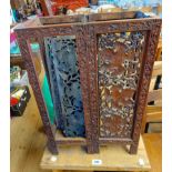 An Eastern carved and pieced hardwood stick stand with decorative vine decorated pierced panels -