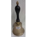 An old brass school style bell with turned ebonised wood handle and acorn finial