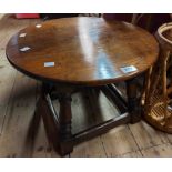 A 50cm diameter vintage oak tea table, set on a joint stool style open stretcher base with turned