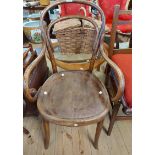 An antique Eastern European bentwood elbow chair with remains of machine pressed decoration to