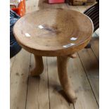 A late African hand carved wood table with dished top and integral triple swept legs - crack