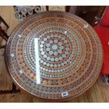 A 68cm diameter mahogany pedestal numismatist's table with decorative coin inset top featuring