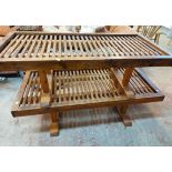 A pair of 1.26m stained pine and mixed wood coffee tables with studded slatted tops, set on standard