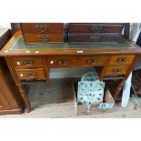A 1.06m Edwardian mahogany writing desk with central frieze drawer, flanking short drawers with