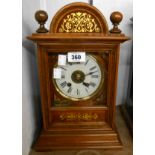 An early 20th Century gilt decorated mahogany cased table alarm clock with large bell to top and