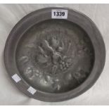 A vintage German Zint pewter dish in the antique style with embossed decoration to central well
